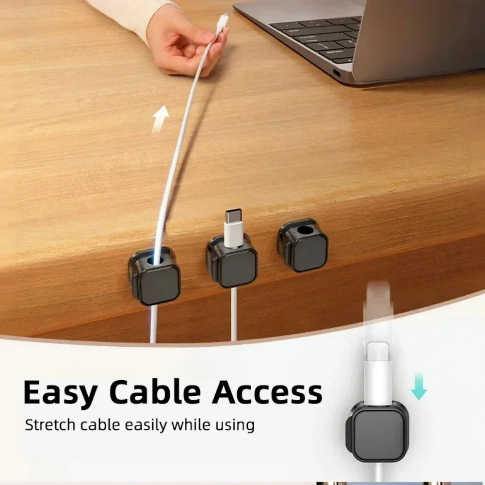 Magnetic cable clips holding charging cables at a desk edge