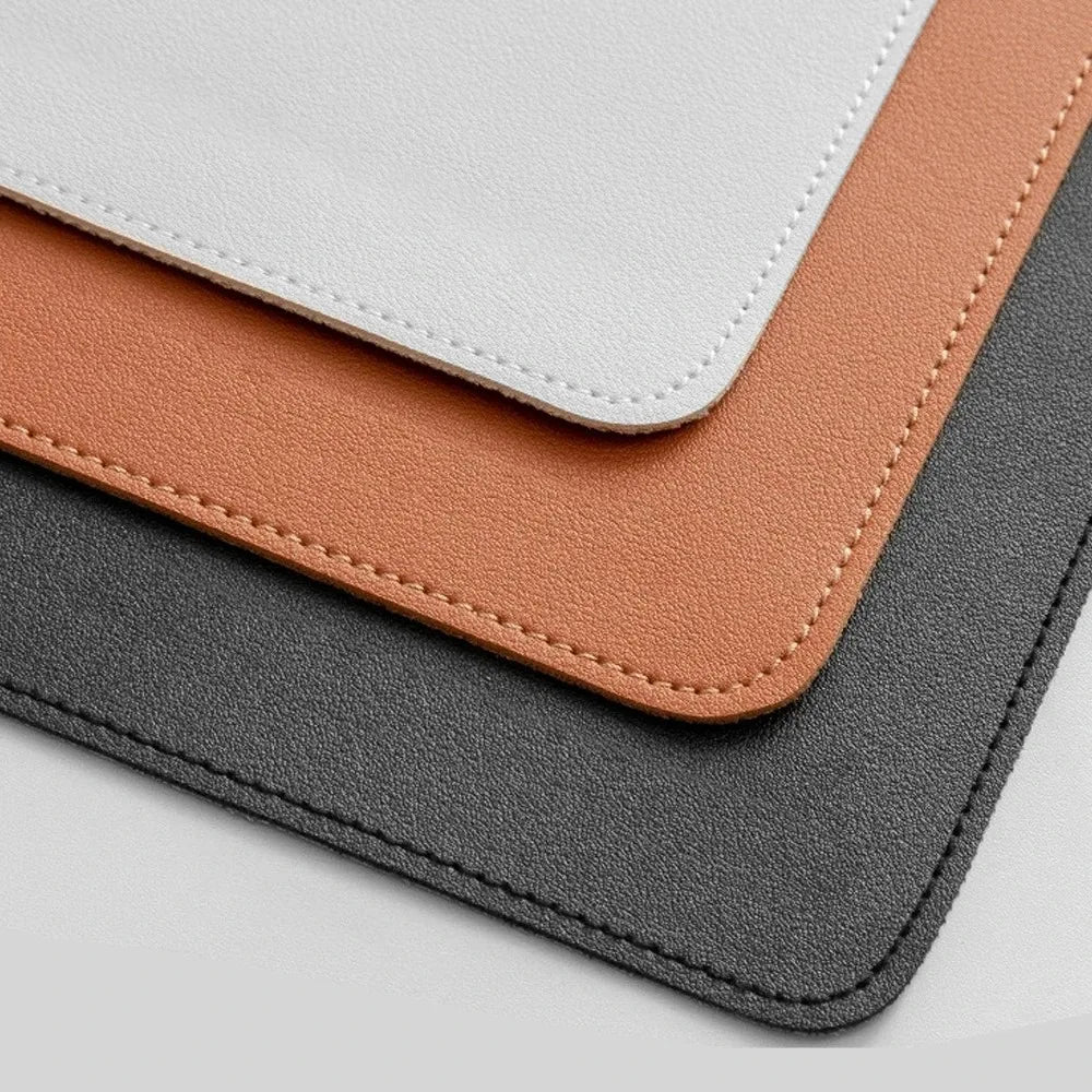 Oversized vegan leather desk mat covering most of a desk surface