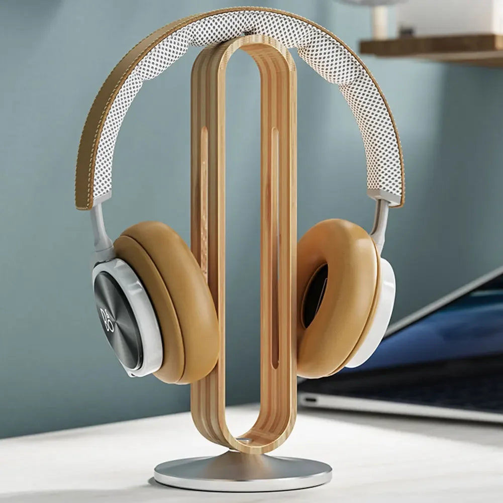 Bamboo and aluminum headset stand displaying headphones on a desk
