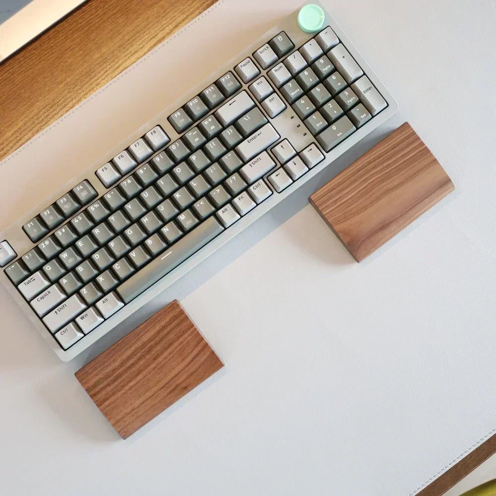 Solid walnut palm rest in front of a compact keyboard