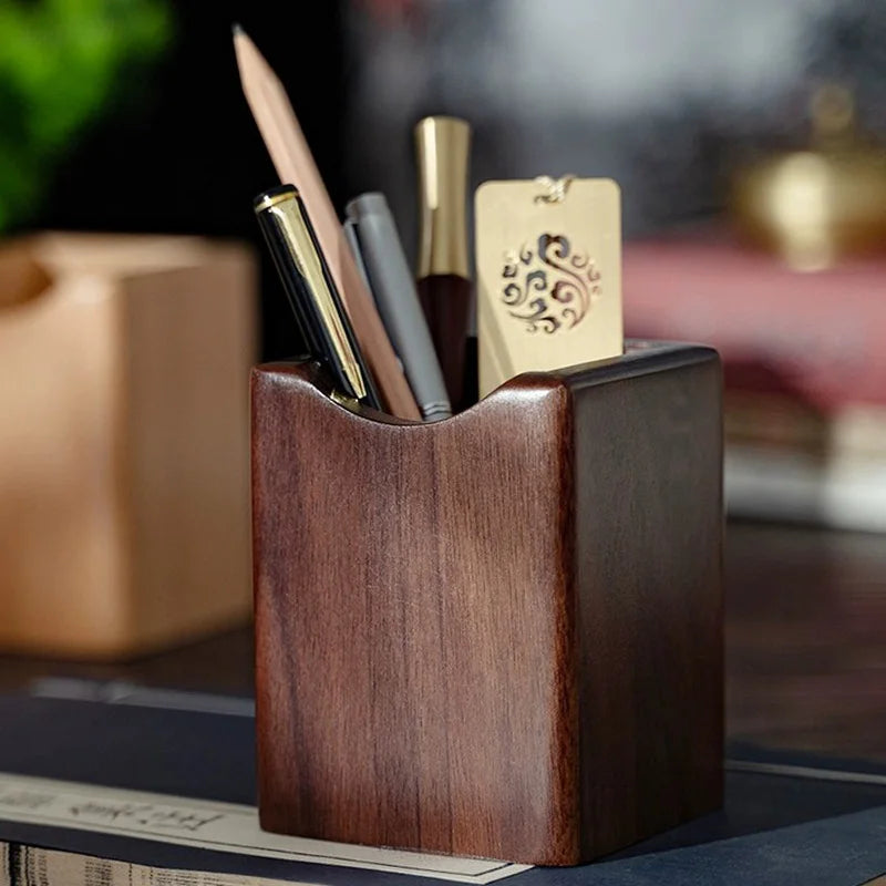 Natural walnut pen holder on a clean desk beside a notebook