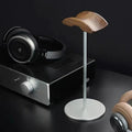 Black walnut and aluminum headphone stand on a minimalist desk
