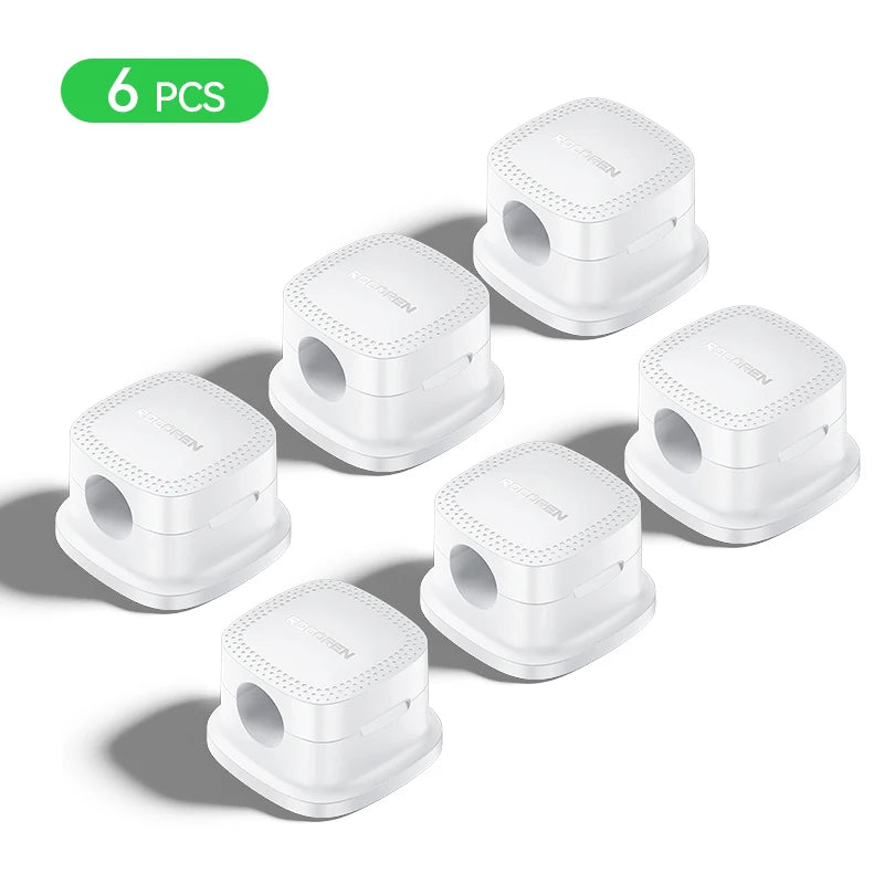 Adjustable magnetic cable holders mounted beneath a desk